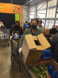 Life Skills Coach Margie McPhail and Eveline Iosefa helping at partner non-profit food delivery service