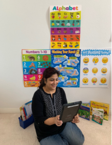 CDS Educator Misbah Saad on floor with ipad