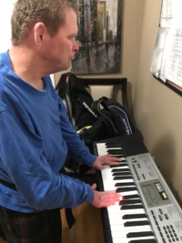 Timothy plays his keyboard