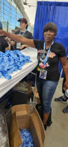 A participant volunteering at Comic-Con by handing out lanyards