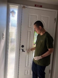 Jonathan cleaning door handle