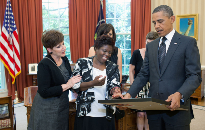 President Barack Obama looks at a painting by Lois Curtis during a meeting in the Oval Office, June 20, 2011. (Official White House Photo by Pete Souza)